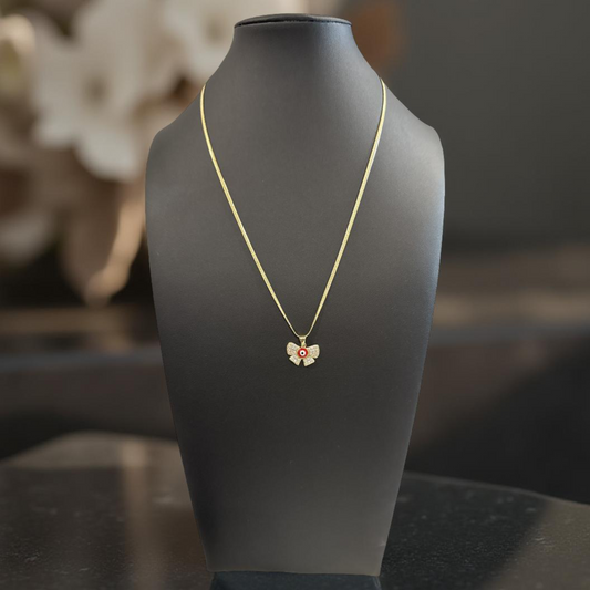 Necklace with a butterfly pendant on a black mannequin bust against a blurred background